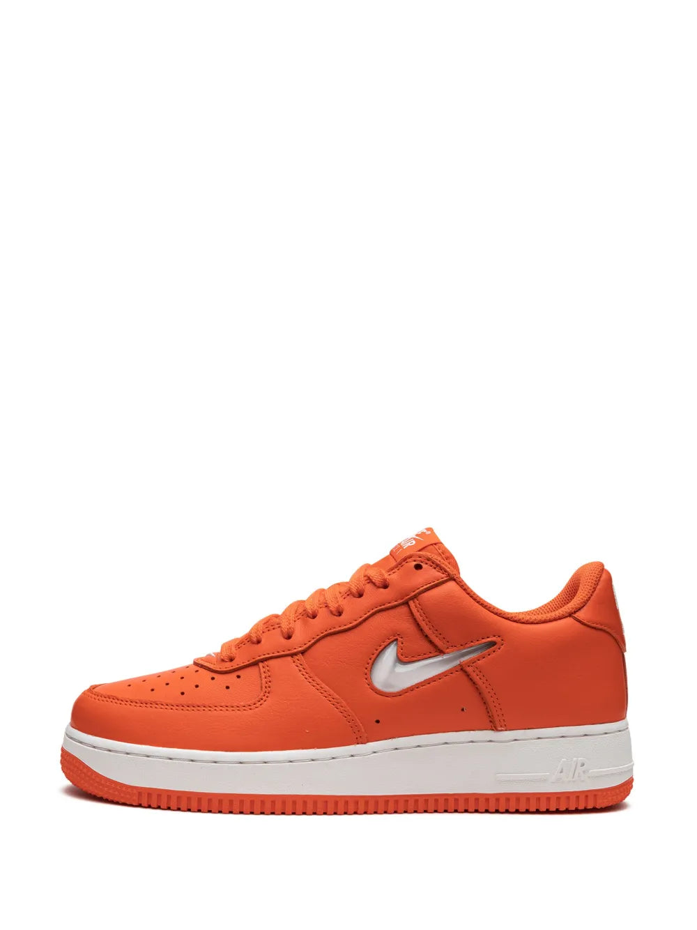 Orange low-top Nike sneakers with white swoosh and textured lace eyelets