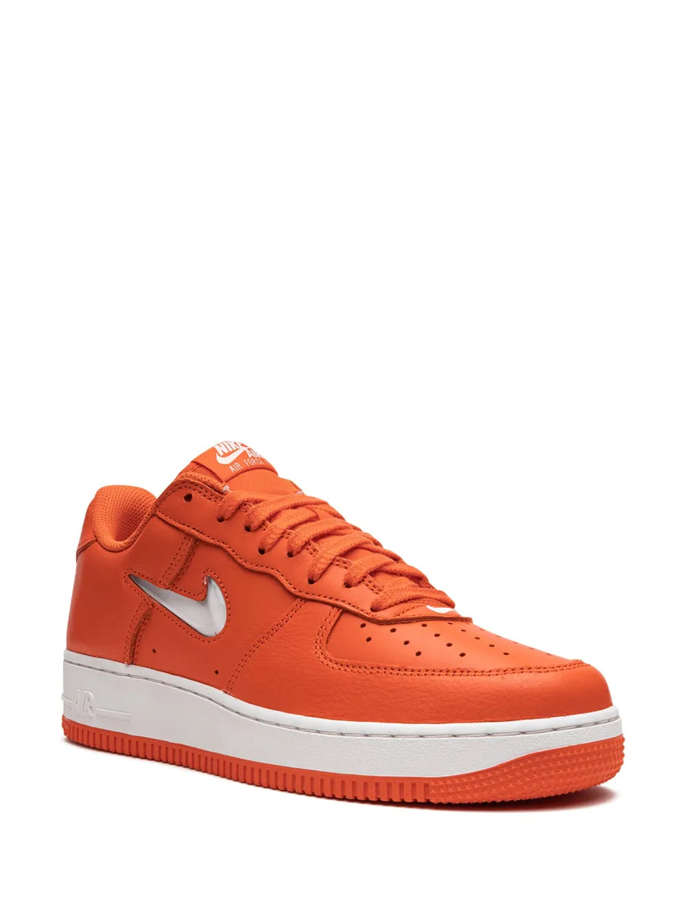 Orange low-top Nike sneakers with white swoosh, perforated toe, and lace-up