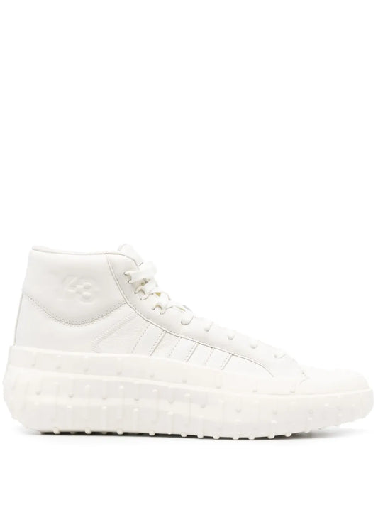 White high-top lace-up sneakers with textured stripes and thick rubber sole