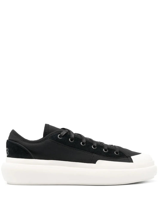 Black low-top lace-up court sneaker with white rubber sole