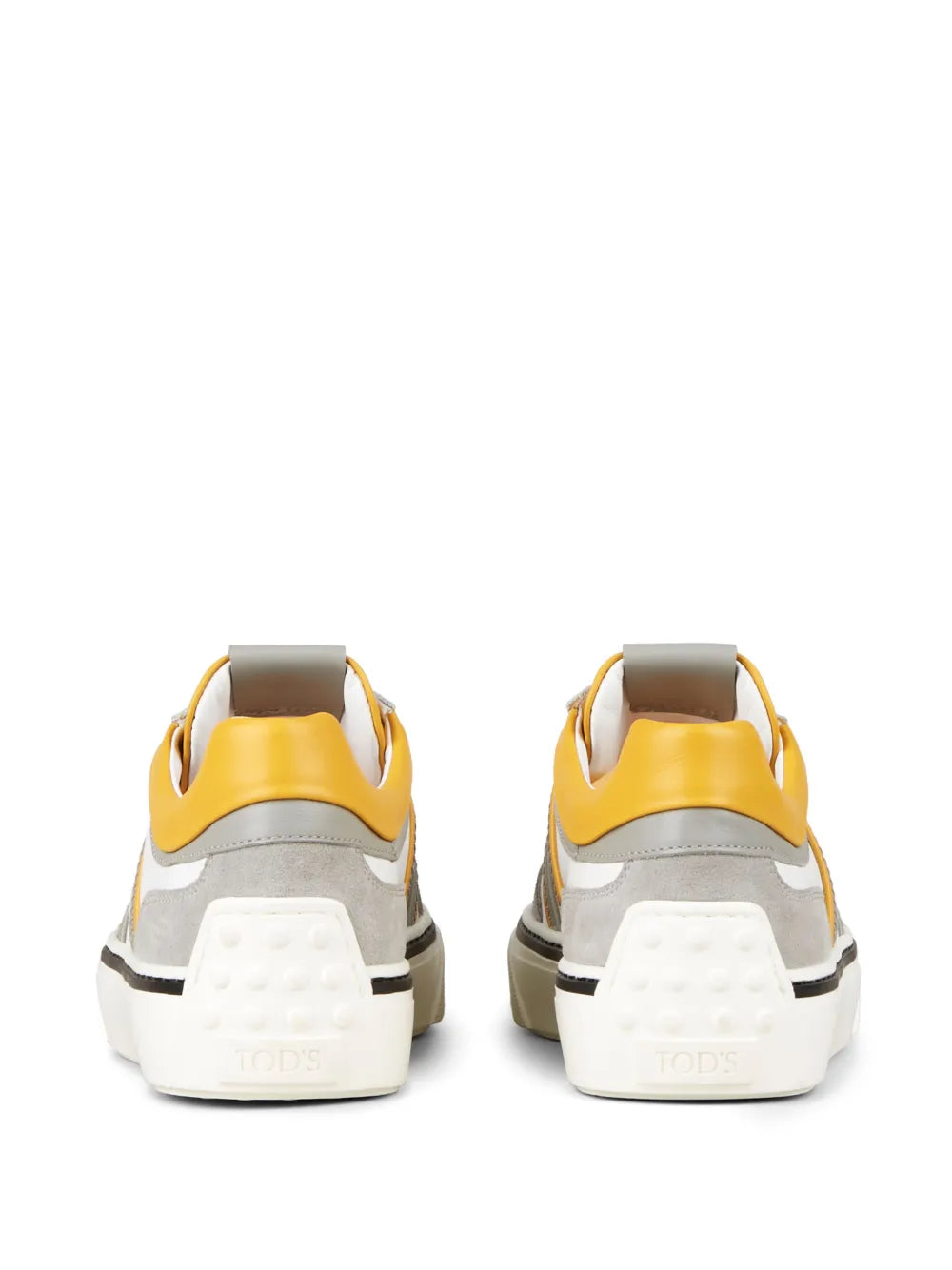 White low-top sneakers with yellow heel tab and gray heel, back view, lace-up.