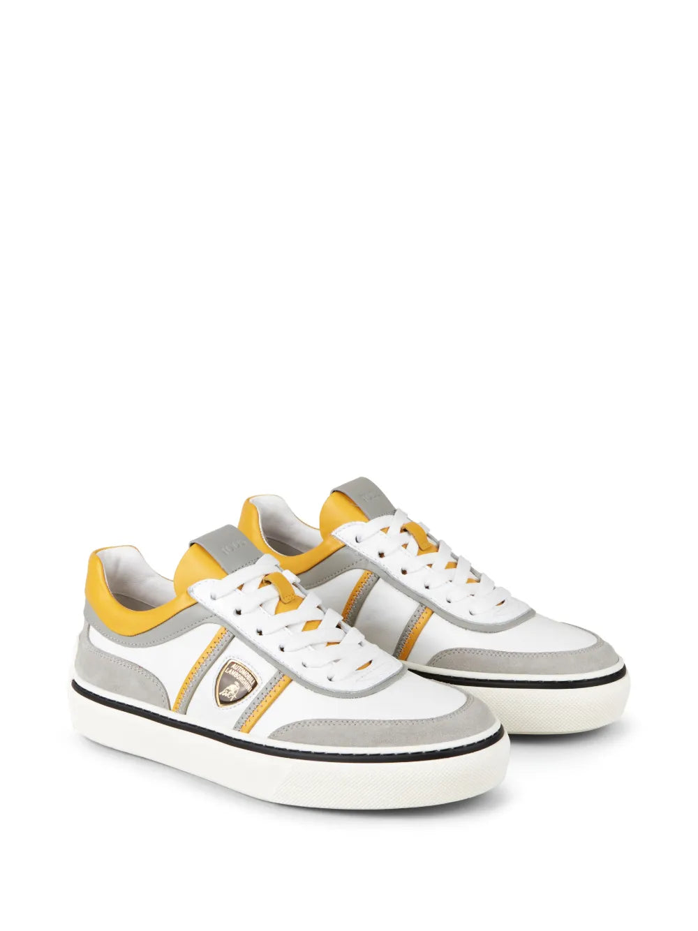 Pair of white low-top sneakers with yellow heel panels and gray side stripes, lace-up.