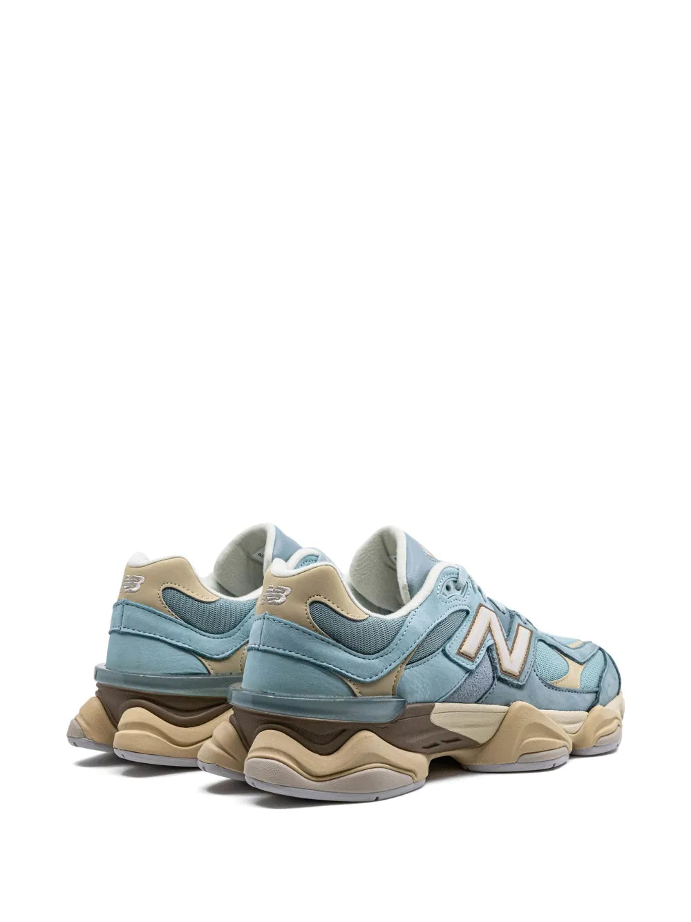 New Balance 9060 blue sneakers rear angled view with beige heel and chunky sole