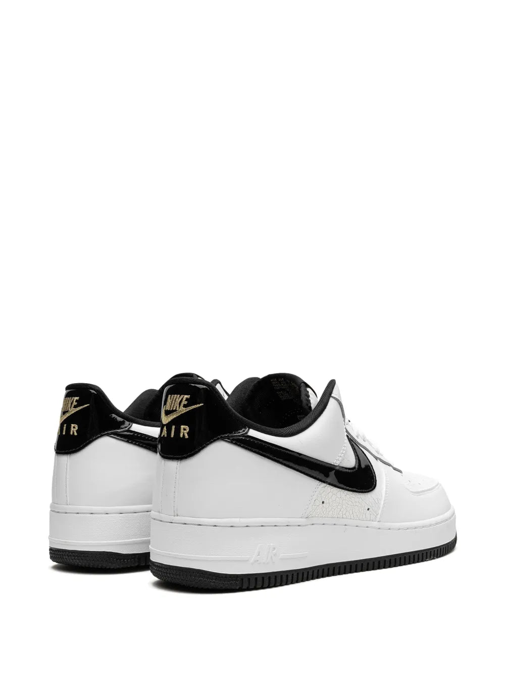White Nike Air Force 1 sneakers with black heel tabs showing AIR branding