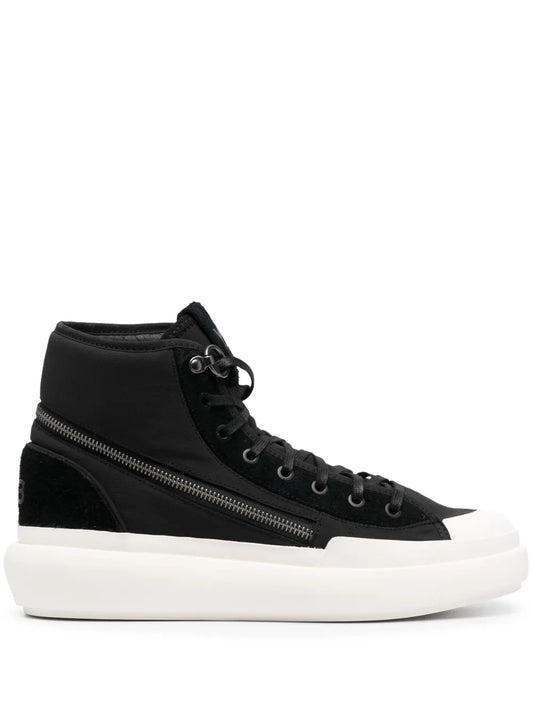 Black high-top sneaker with lace-up front, side zipper, and white rubber sole