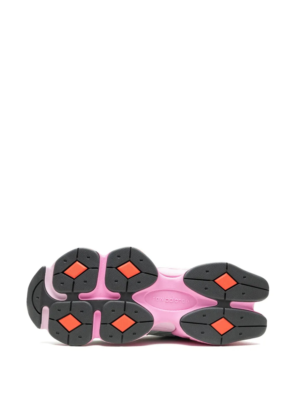 New Balance sneaker outsole with black rubber traction pods and pink midsole edge