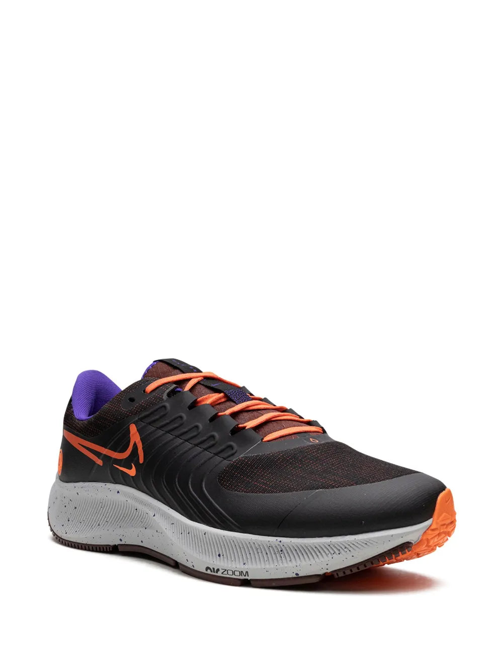 Nike running shoe with black upper, orange swoosh and laces, purple lining, side view