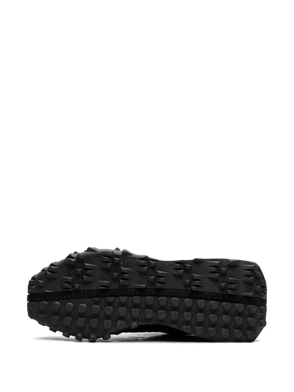 Black lugged rubber outsole for New Balance XC72 D sneaker, textured tread pattern
