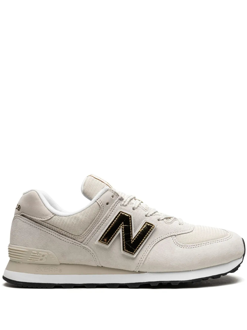 New Balance 574 sneakers in off-white and light grey with black “N” logo, laces, rubber sole