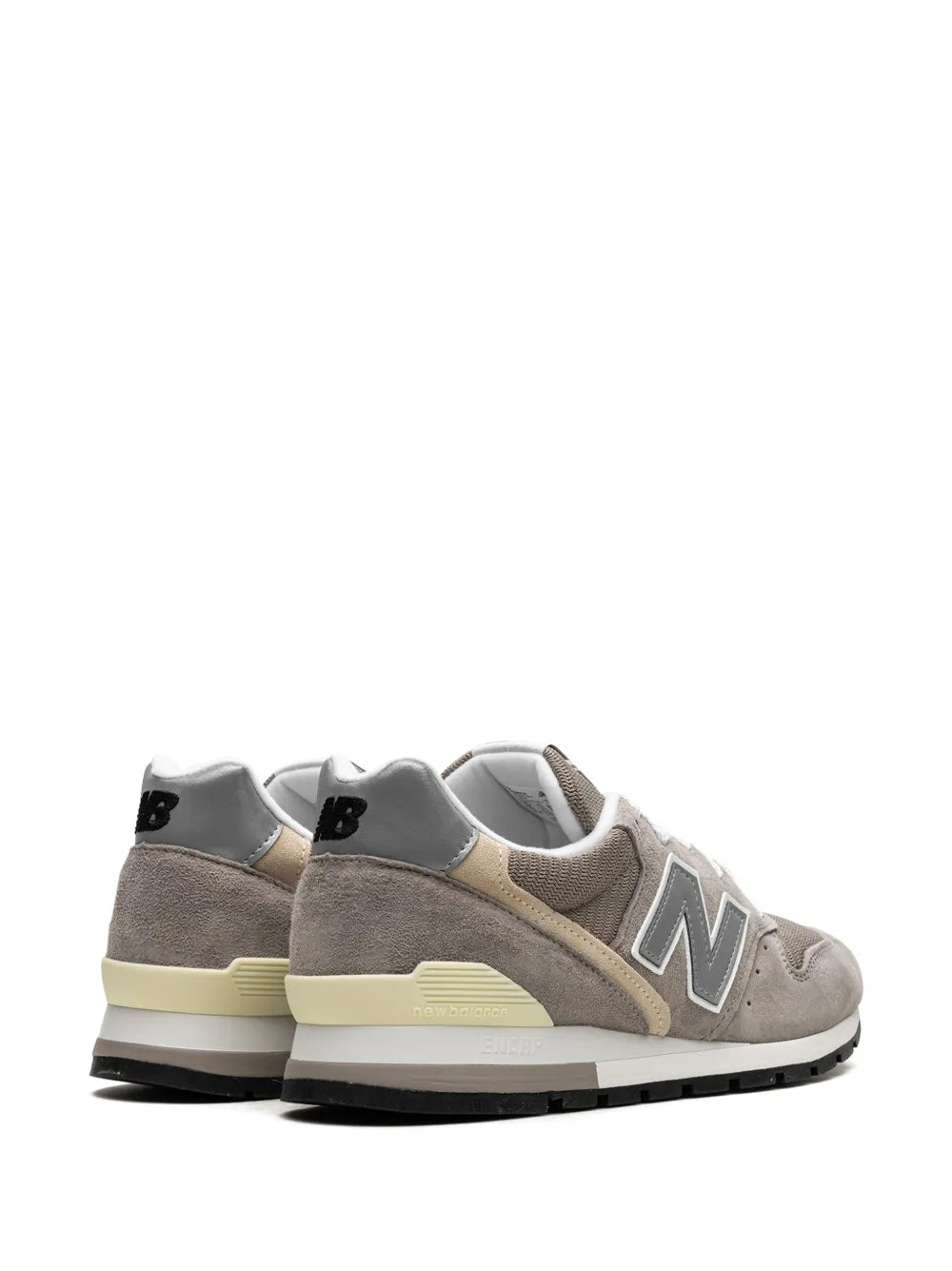 Two grey low-top sneakers, N side logo, white lining, and heel pull tab