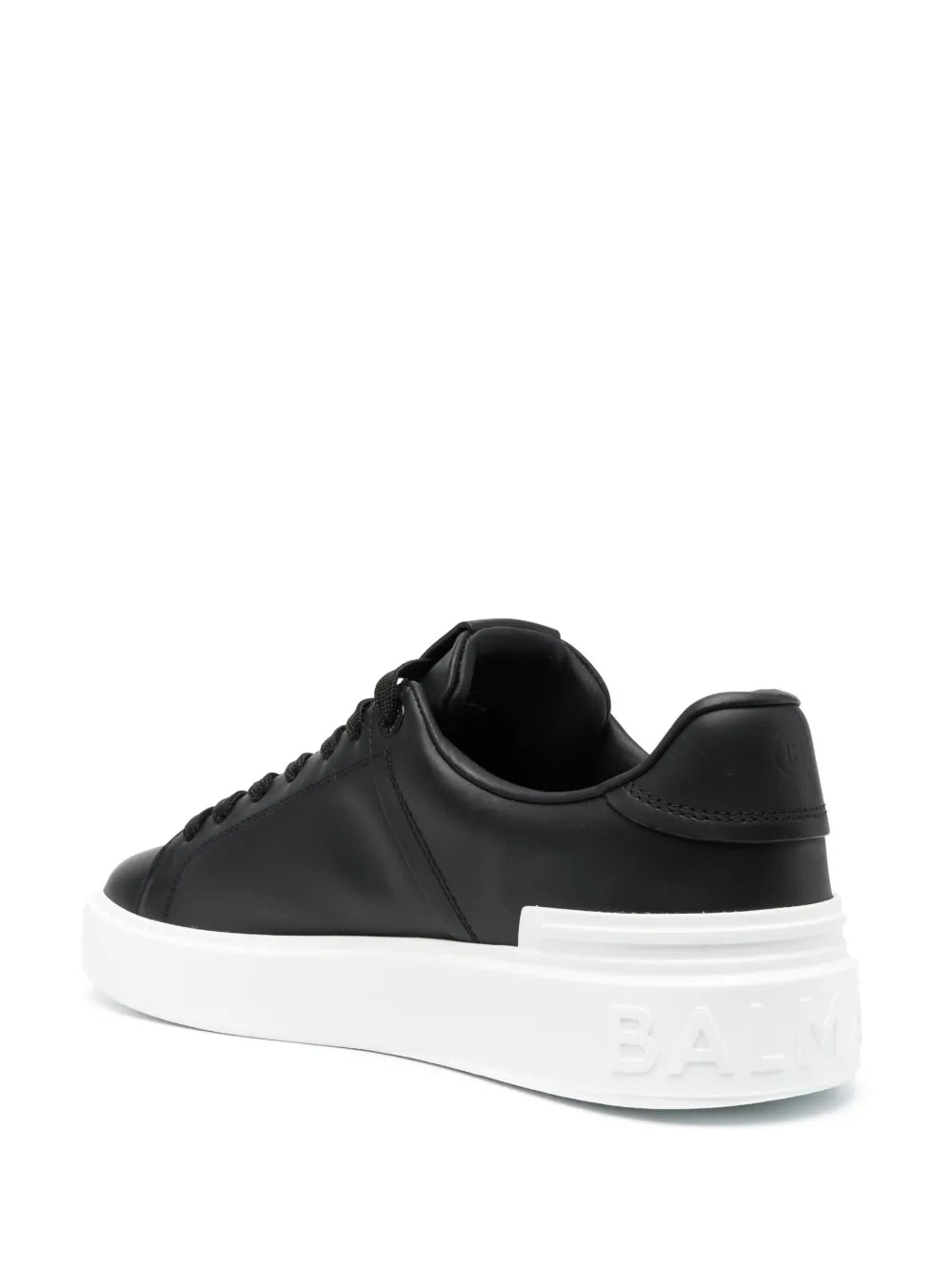 Black low-top sneakers with padded collar and embossed logo on white sole