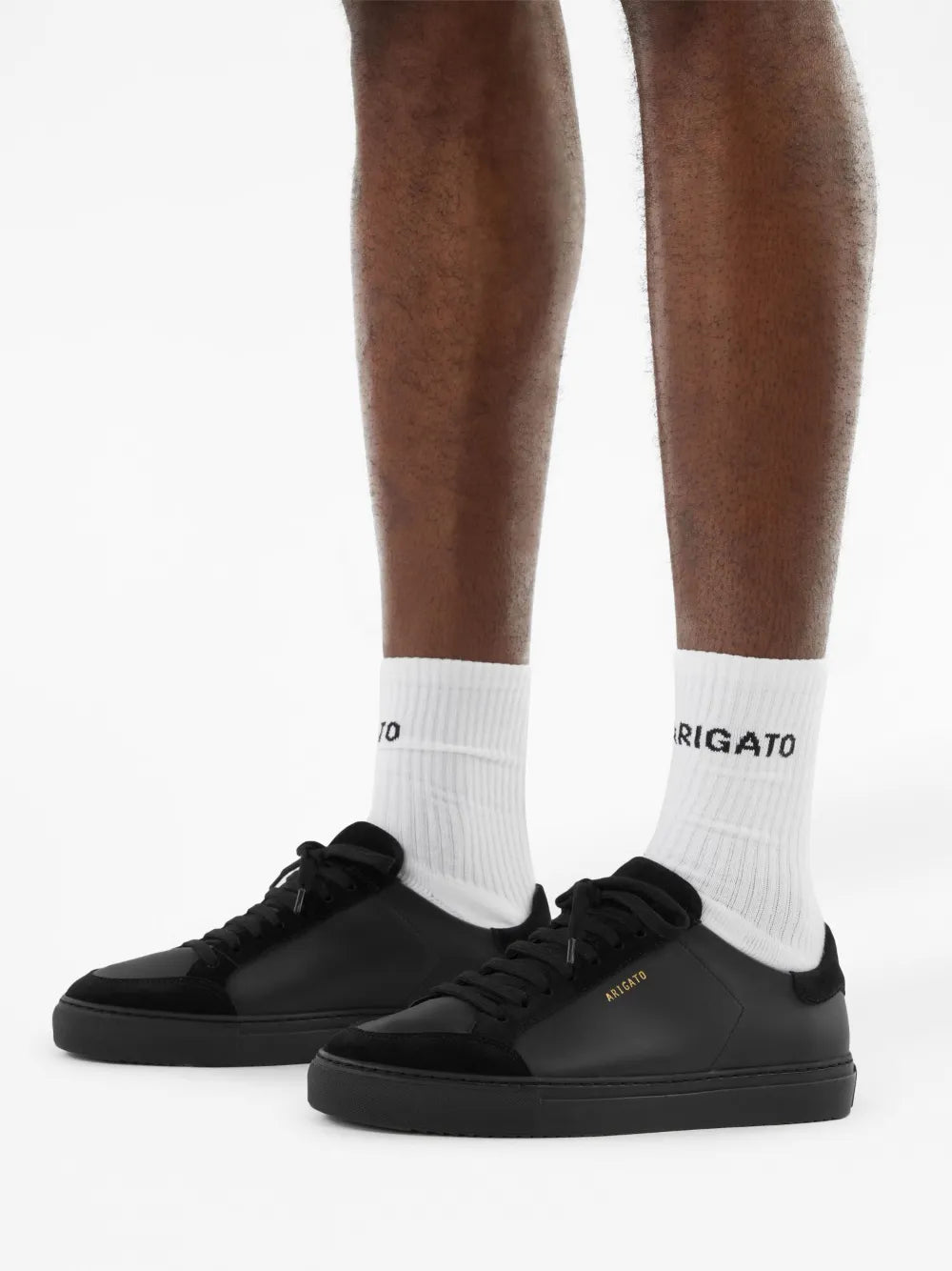 Black low-top sneakers with white crew socks