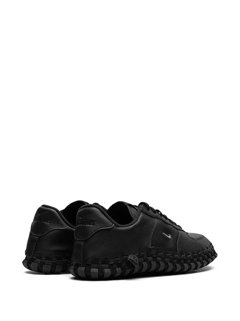 Black low-top sneaker with heel tab and lace-up front, rugged tread sole