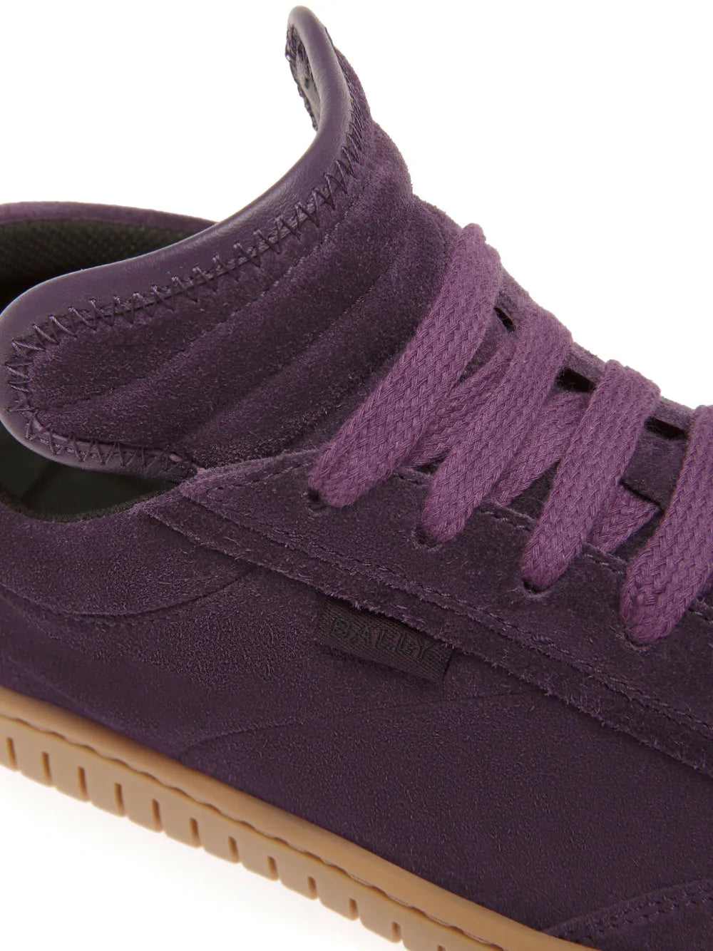 Purple suede lace-up sneaker upper with stitched seams and textured lace placket
