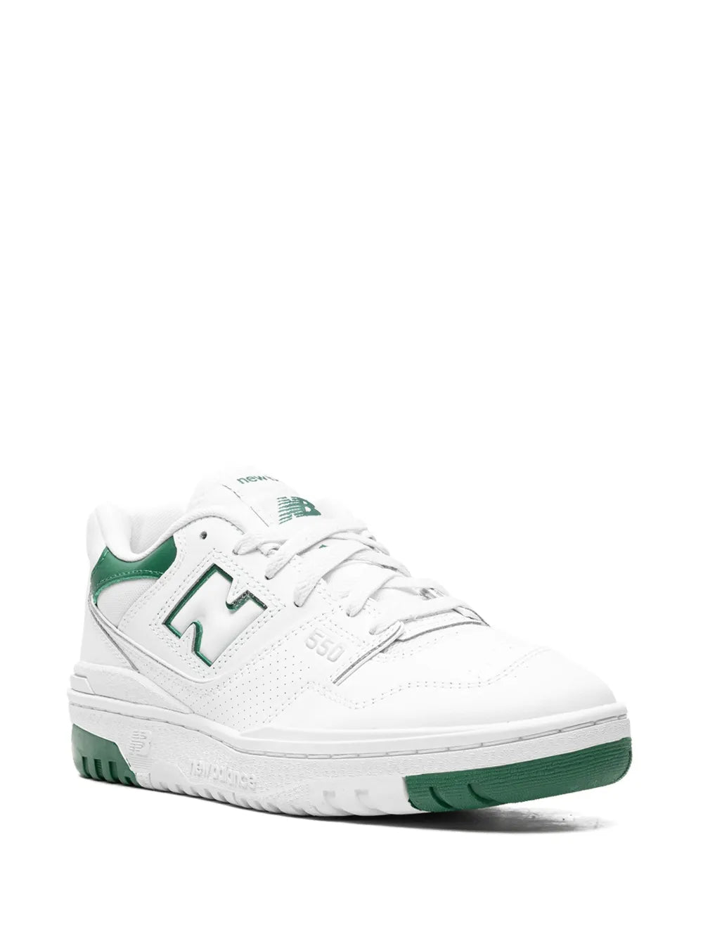 White low-top sneakers with green accent collar, lace-up front, and cushioned sole