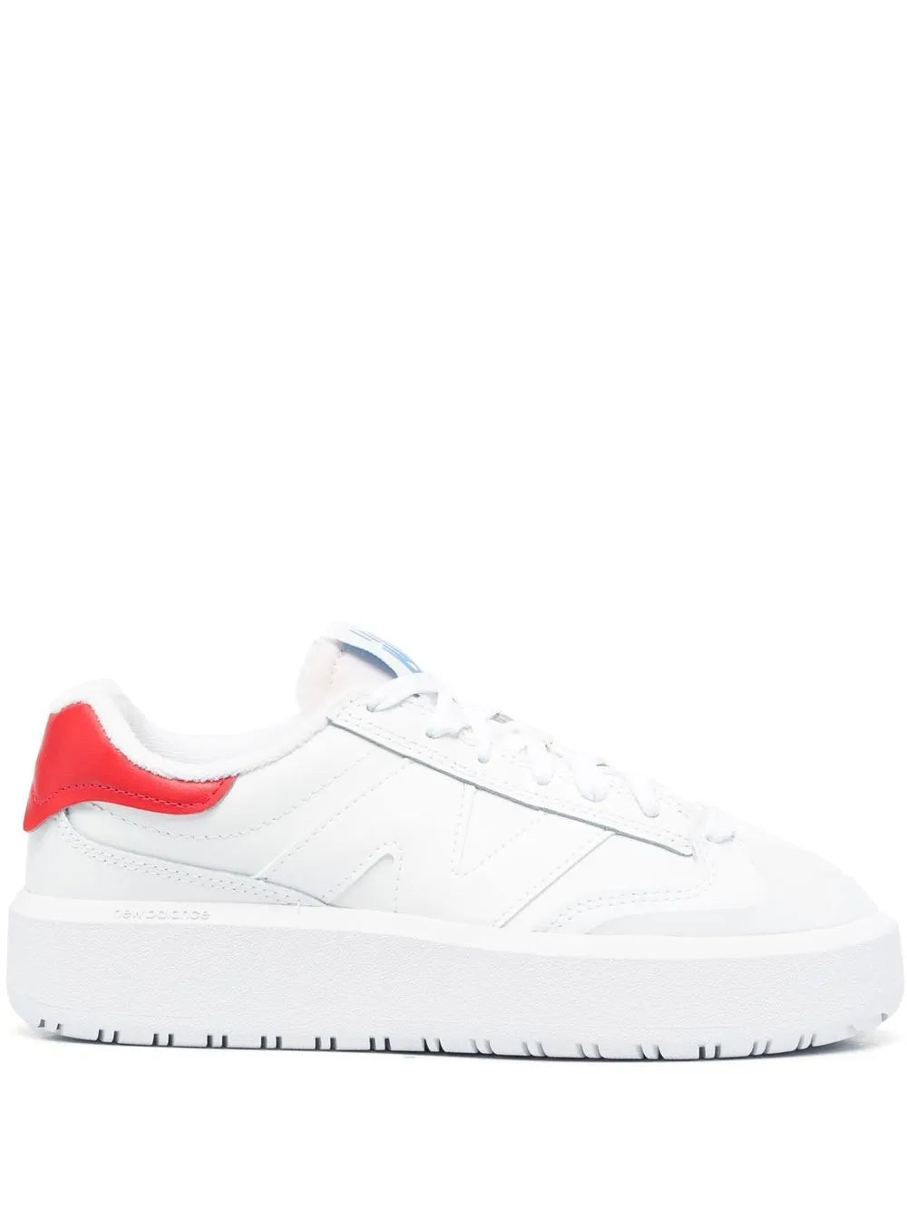 White low-top sneakers with red heel and blue logo detail, lace-up front