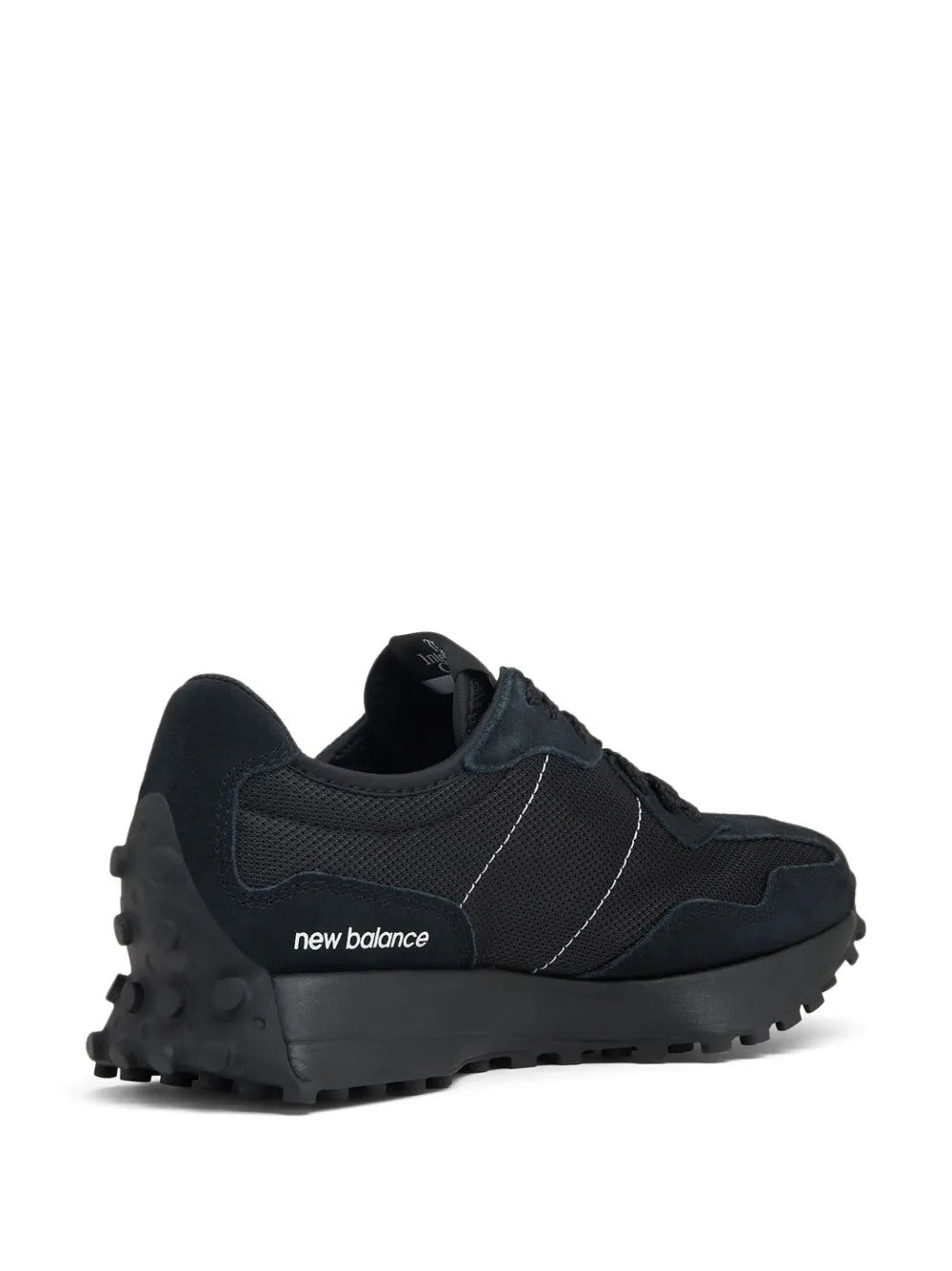 Black low-top sneakers with 'new balance' logo on side and chunky outsole
