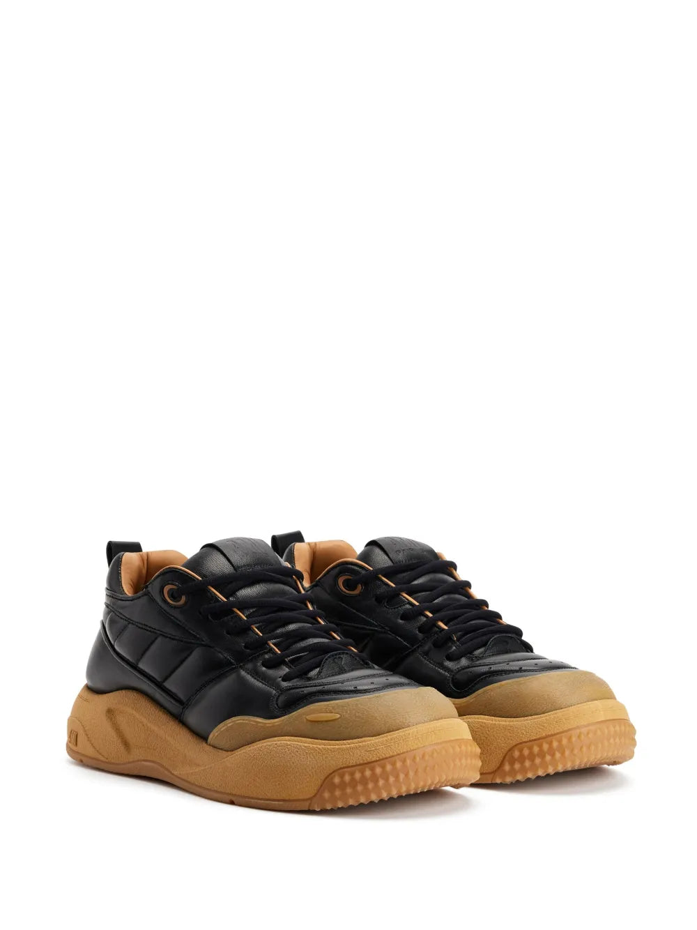 Black panelled sneakers with tan gum soles, lace-up, shown from top angle