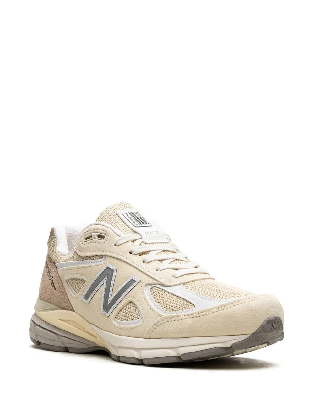 New Balance 990v4 cream sneakers, front angled view with lace-up upper