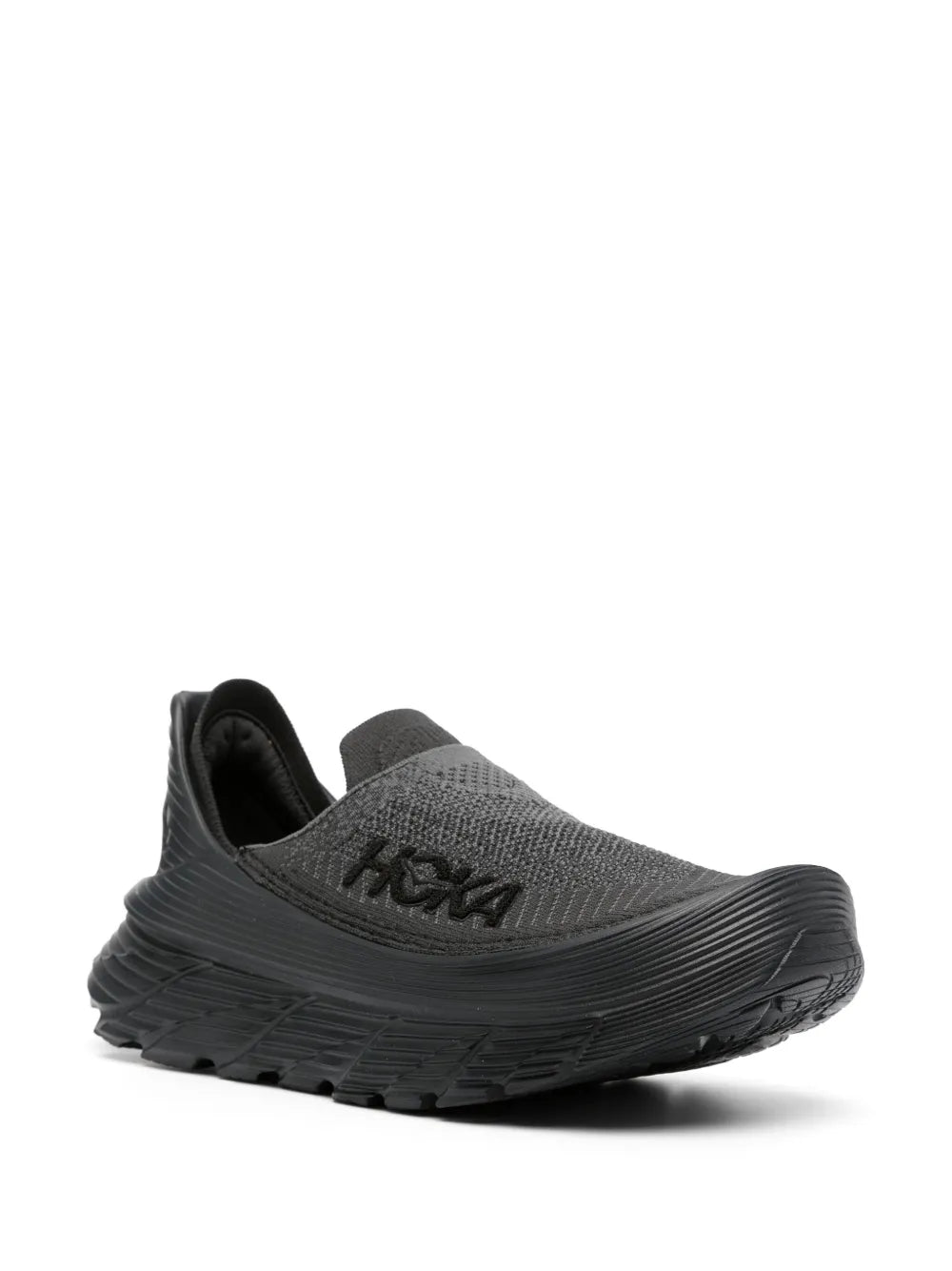 Black slip-on sneakers with textured upper, HOKA logo, and sculpted outsole