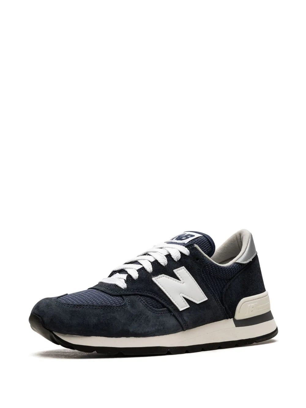 Navy New Balance 990 V1 sneakers from side angle, white laces, cream heel stripe