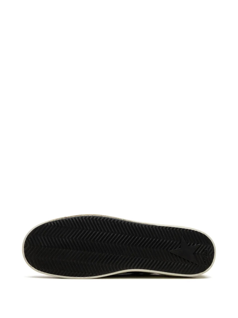 Black sneaker outsole with textured tread pattern on a cream edge sole.