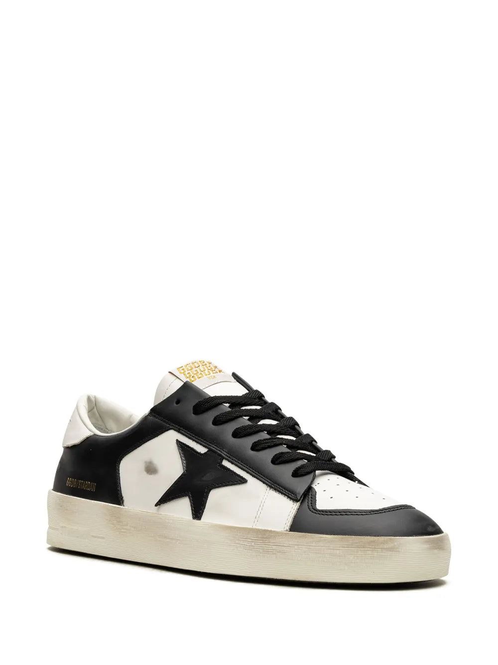 Black and white low-top sneakers with large side star and lace-up closure.