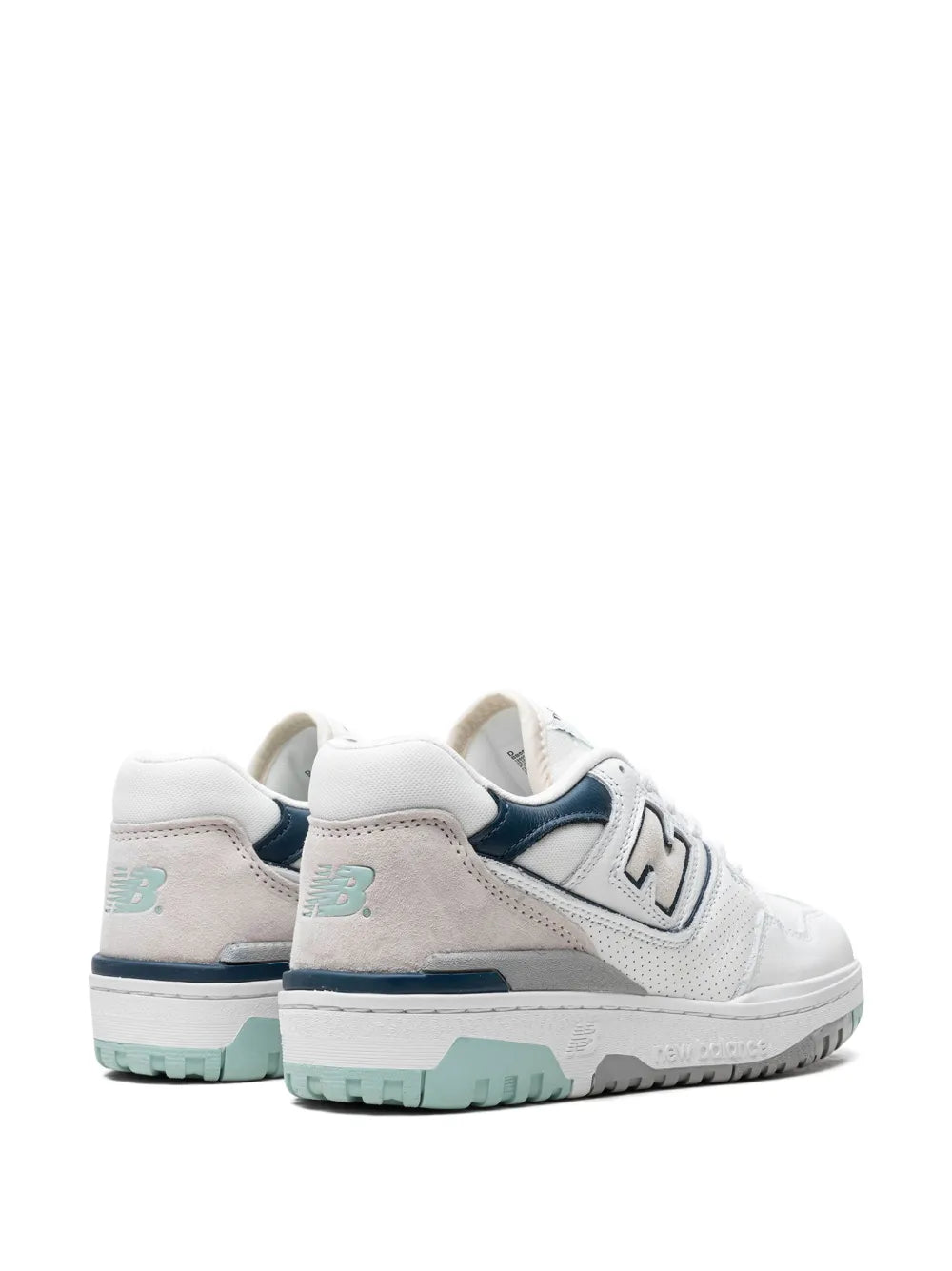 White low-top sneakers, back view, beige paneling and navy heel collar