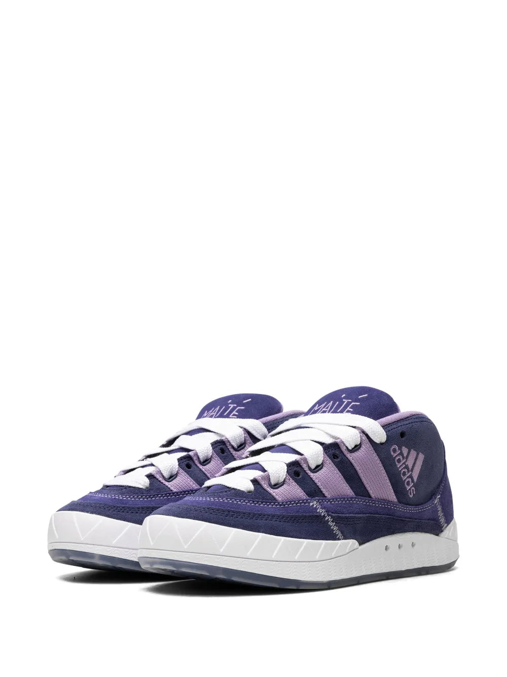 Two navy suede mid-top sneakers side-by-side with white laces and contrasting panels