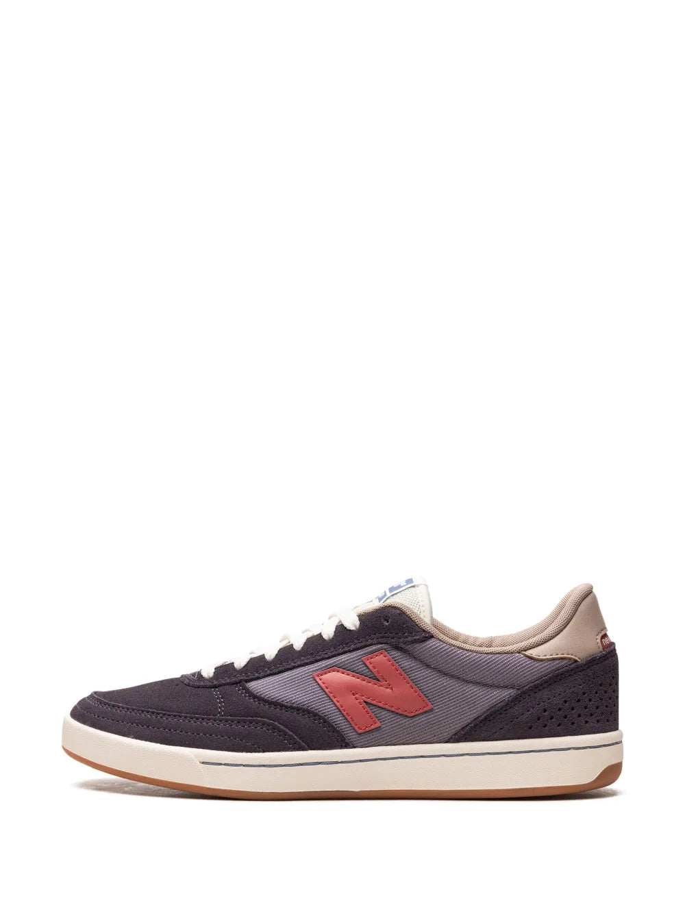 Dark navy low-top sneakers with red N logo, white laces, and tan collar lining