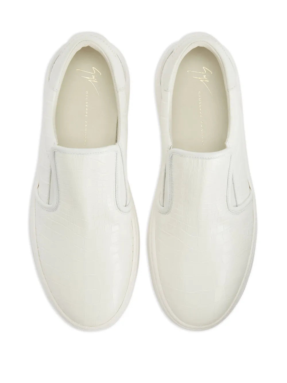 White slip-on sneaker interior view with smooth leather lining and stitched seams