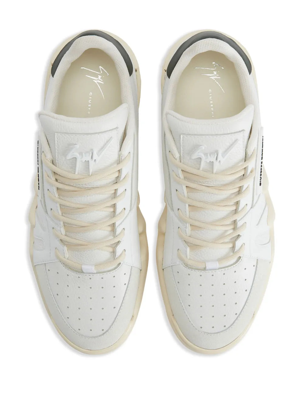 White leather lace-up sneakers, front view with logo patch and perforated toe panel.