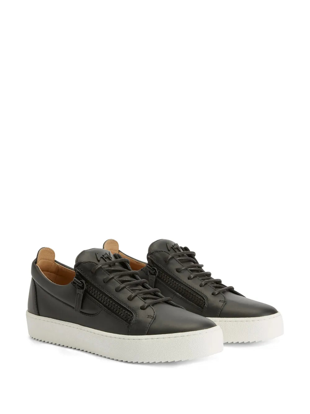 Pair of black low-top sneakers with lace-up front and white rubber soles