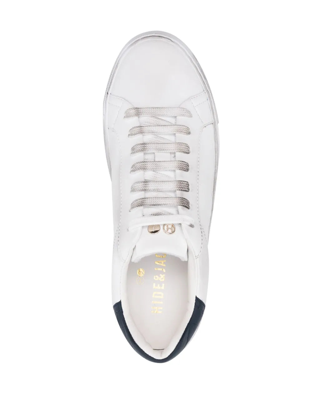 White lace-up sneaker with visible insole lettering and navy-trimmed collar