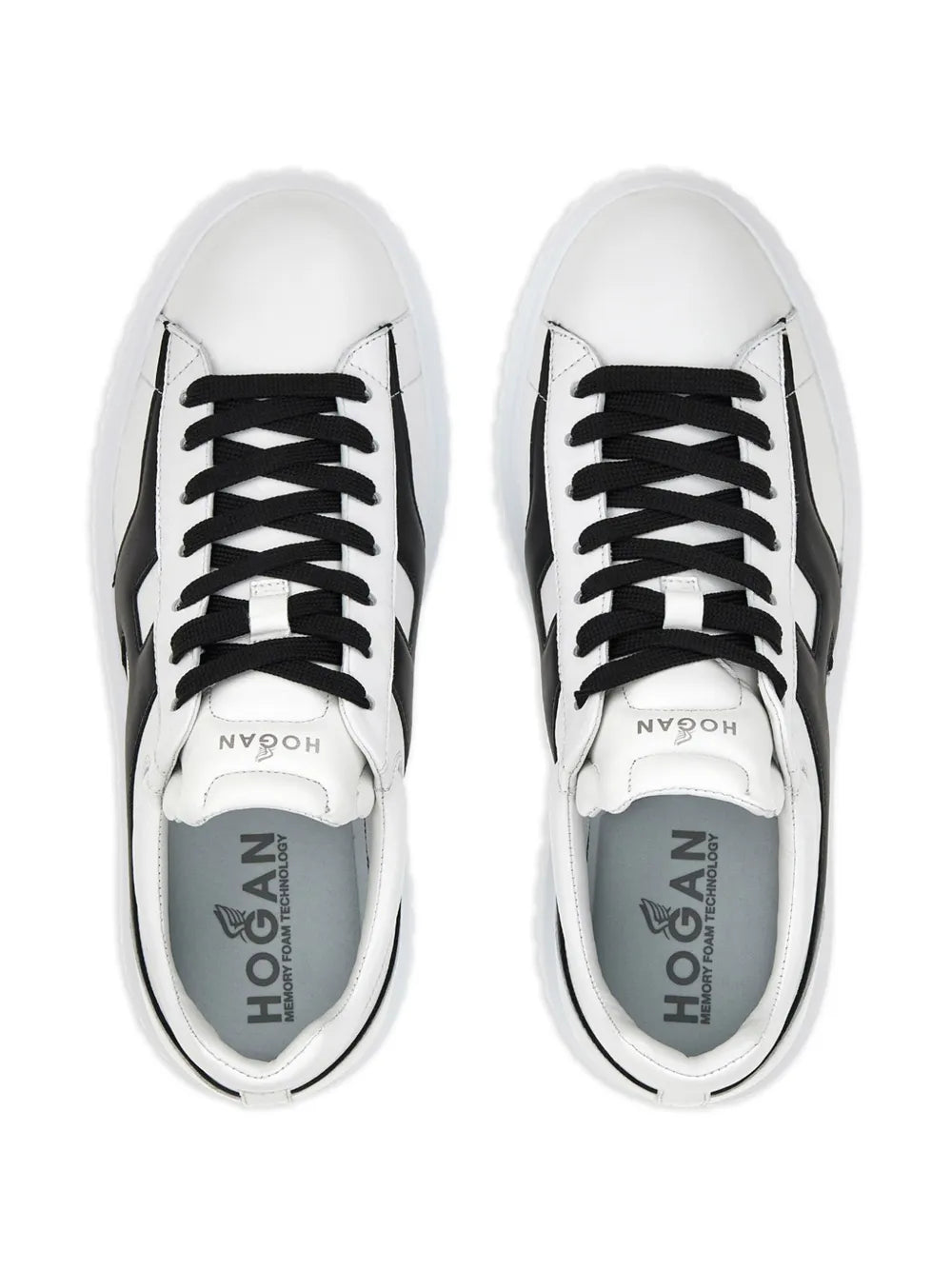 Pair of white sneakers with black laces and HOGAN logo on tongues