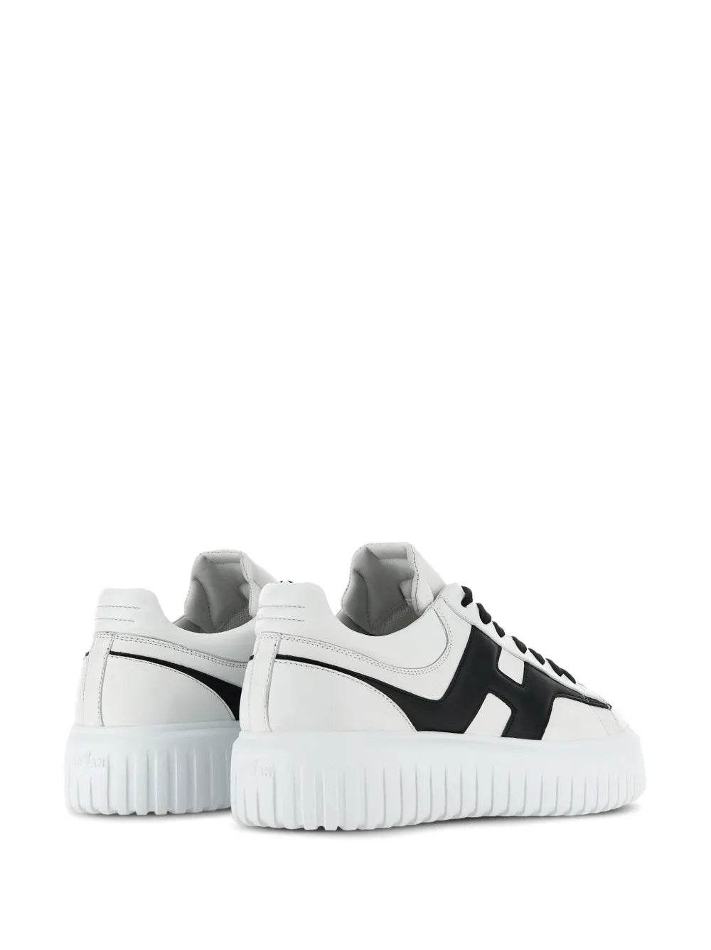 White and black sneakers viewed from heel and side, chunky ribbed sole