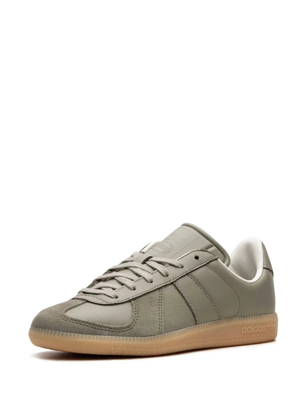 Gray low-top sneakers with lace-up, side stripes, and beige gum sole