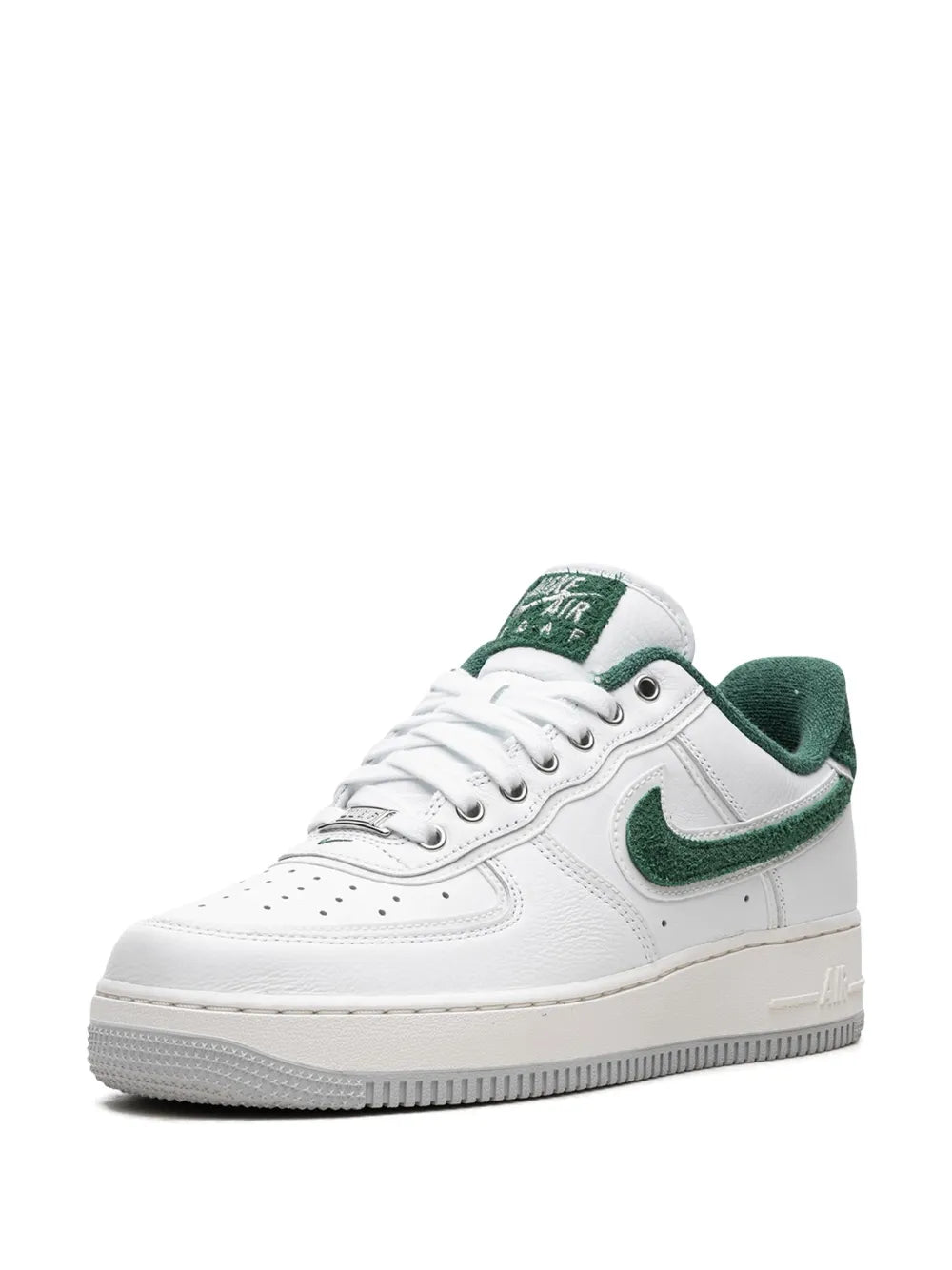 White and green low-top sneakers, front angled view with green swoosh and laces