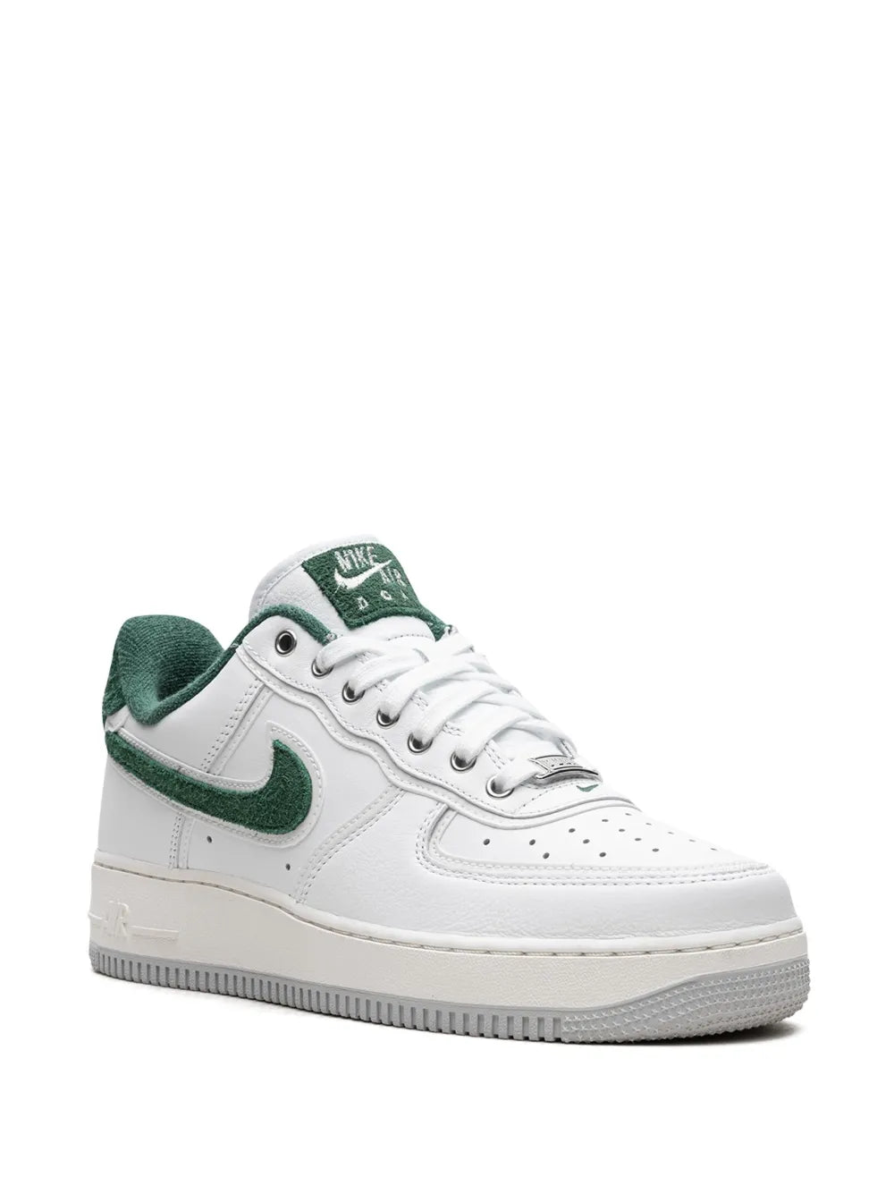 White and green low-top sneakers, side view with green swoosh and lace-up tongue
