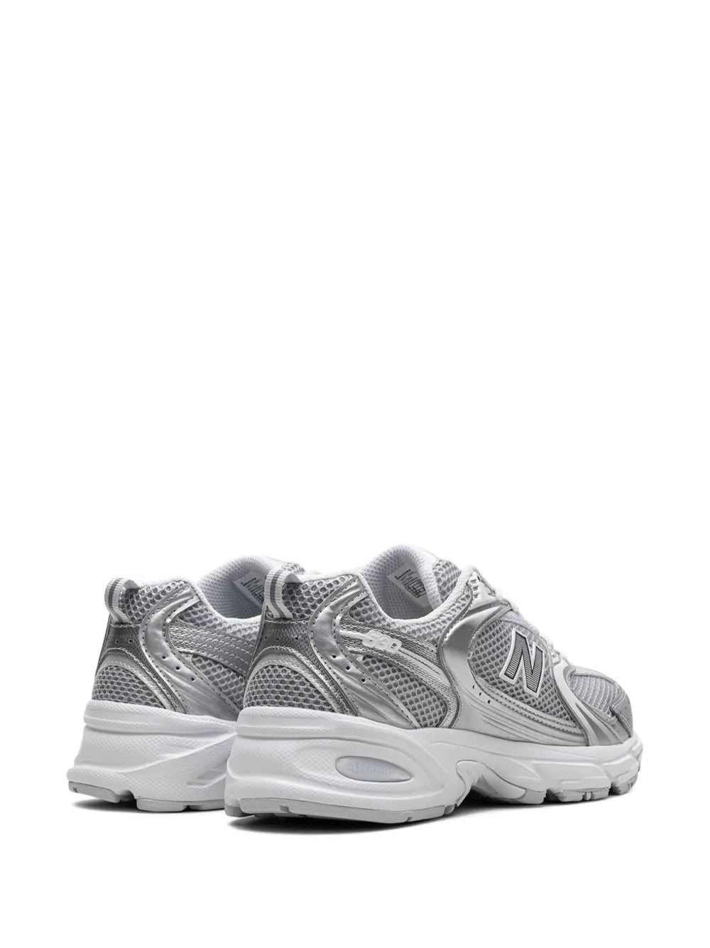 New Balance 530 sneakers in silver metallic, rear-quarter angle with padded heel