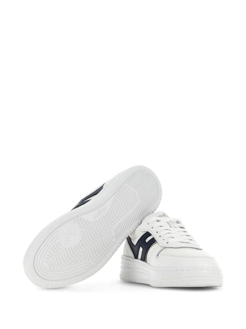 White sneakers with textured rubber outsole visible on side view
