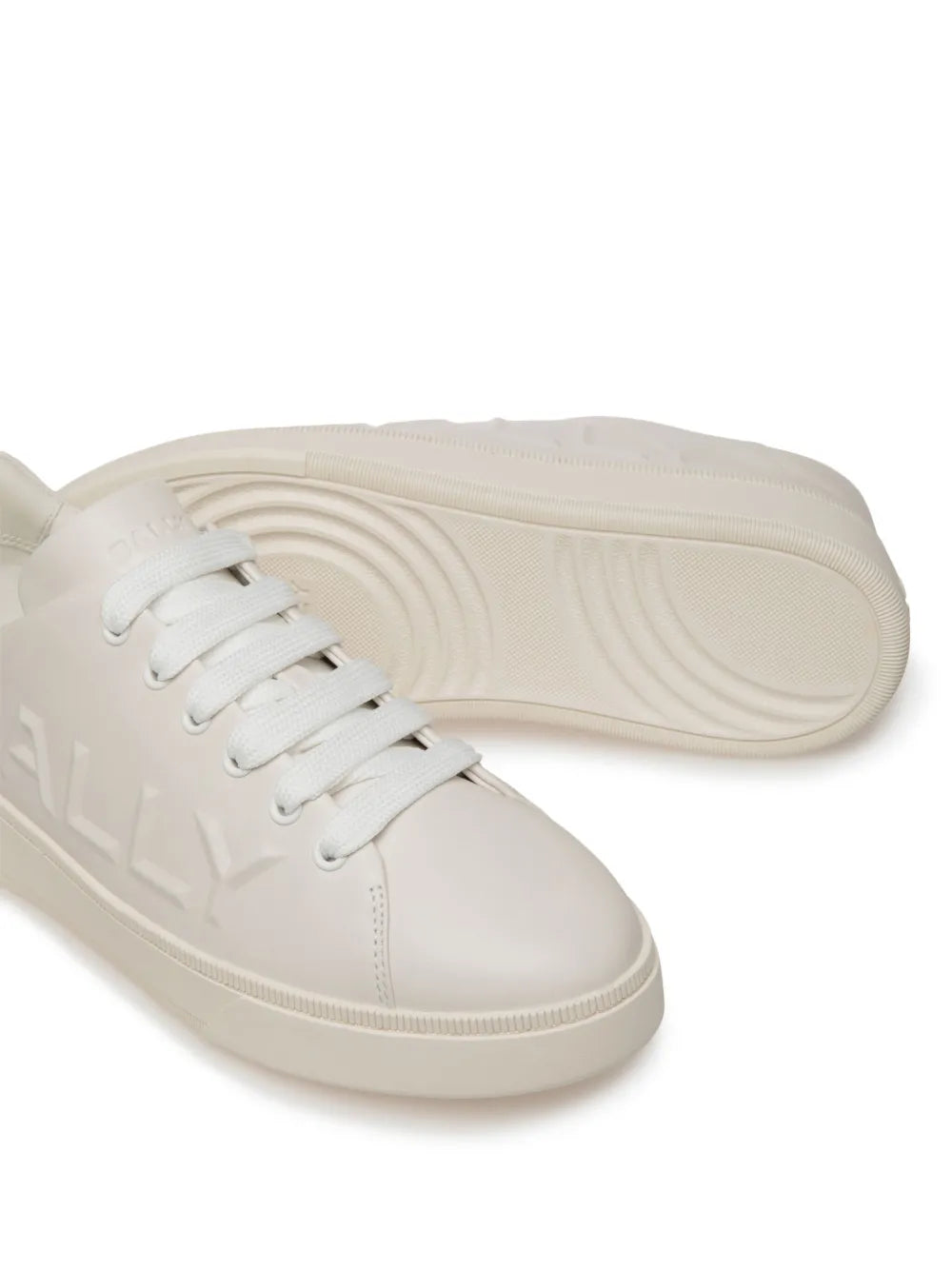 White leather trainers with textured rubber sole tread