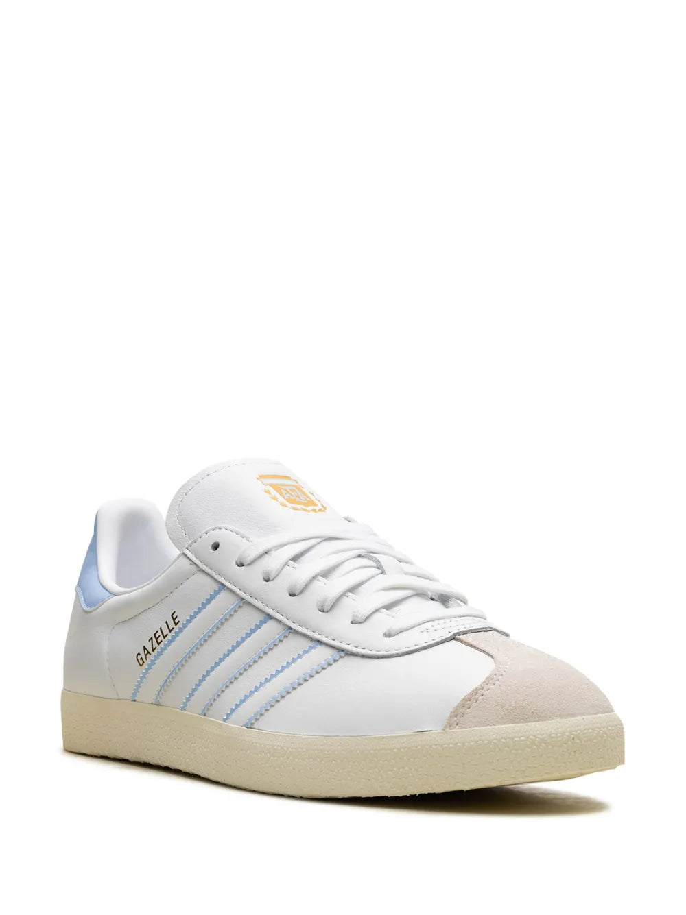 White low-top leather sneaker with blue three-stripe detailing and gum sole