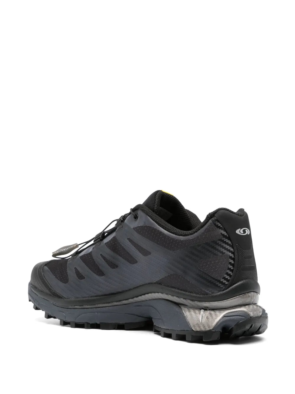 Salomon black trail running shoe, side view with gray overlays and deep tread