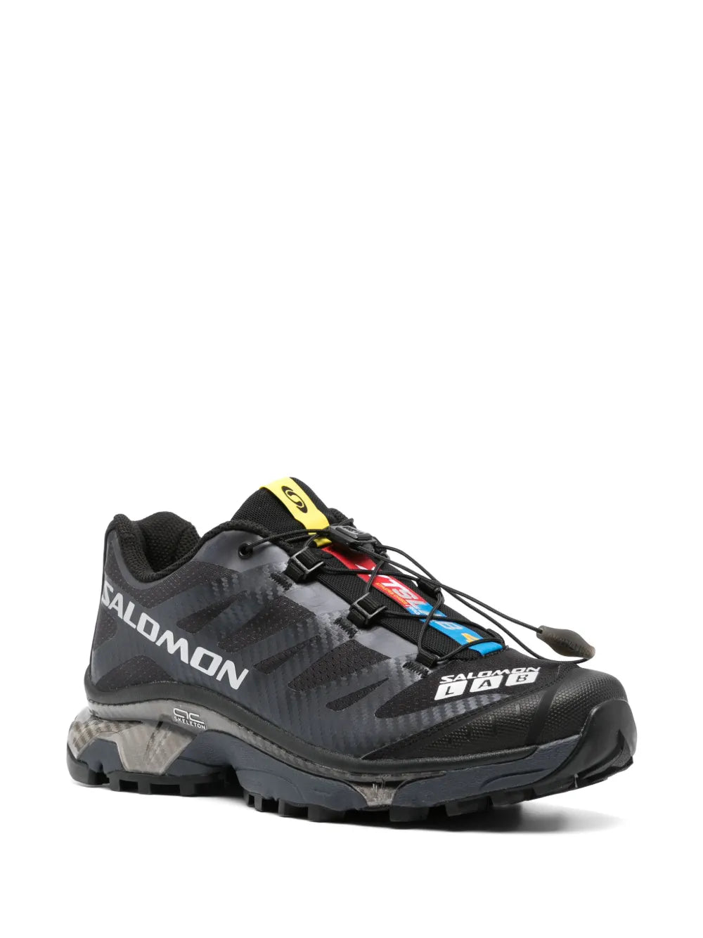 Salomon black trail running shoe, yellow heel pull tab, rugged lug outsole