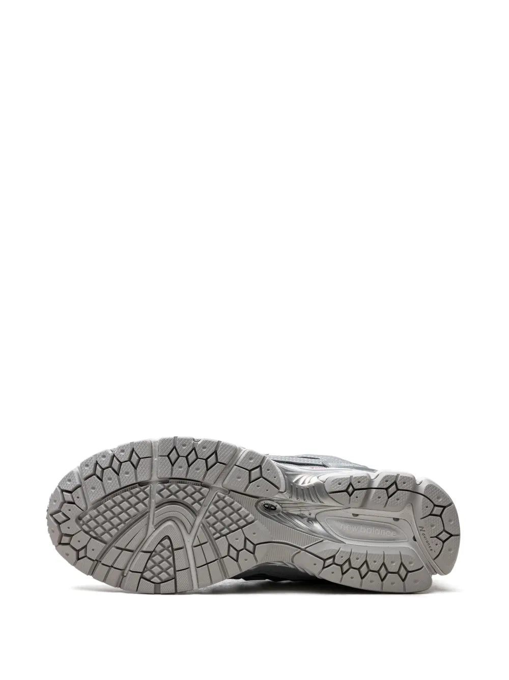 Grey sneaker outsole with patterned rubber tread and hex-style traction