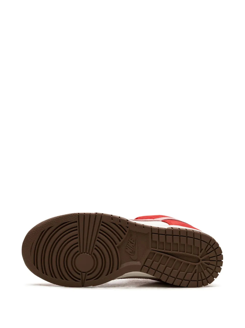 Treaded brown rubber outsole on red and white Nike low-top sneaker
