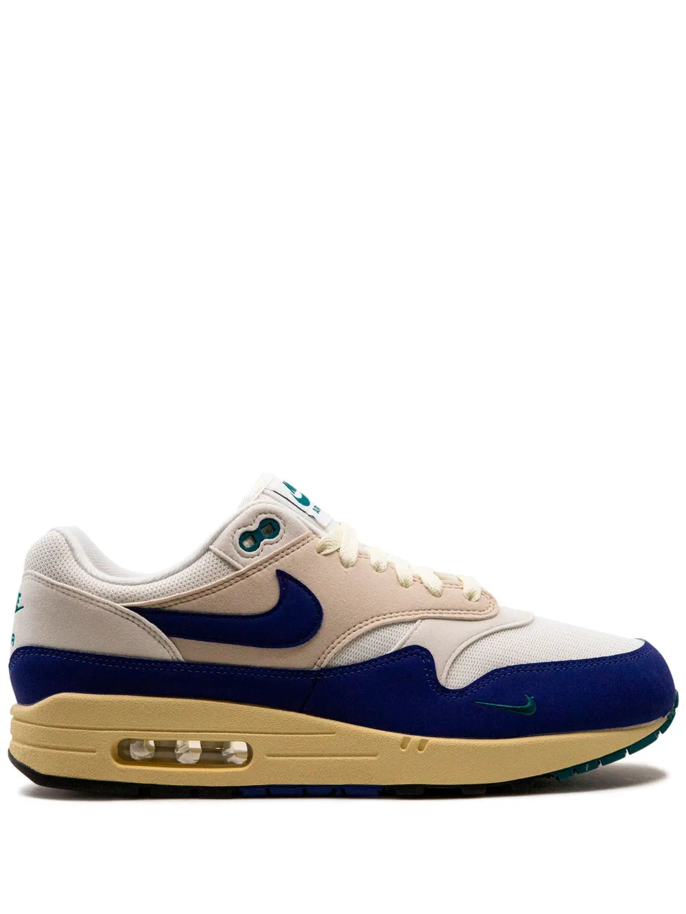 Nike Air Max 1 sneaker in white with navy overlays, teal accents, and visible air unit