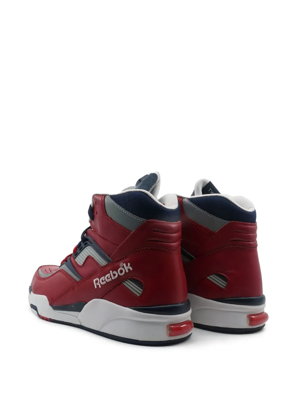 Red high-top Reebok sneakers with gray heel tabs, navy collar, and white midsole
