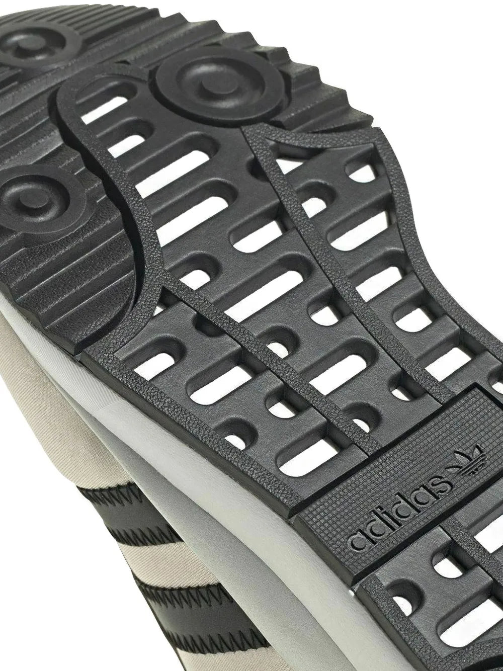 Black adidas SL Andridge outsole detail with perforated tread over light sole.